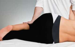 Physical therapy session with therapist stretching patient. - Can You Get Taller Going to a Chiropractor