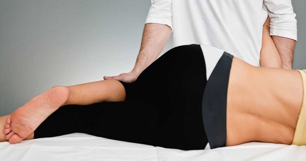Can You Get Taller Going to a Chiropractor Physical therapy session with therapist stretching patient. - Can You Get Taller Going to a Chiropractor