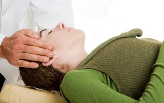 Chiropractor adjusting patient's neck - Common Myths About Chiropractic Care